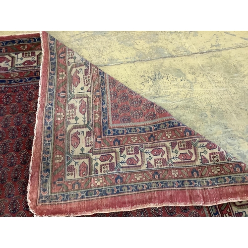 1097 - A Salouk red ground carpet, 350 x 265cm. Condition - poor to fair