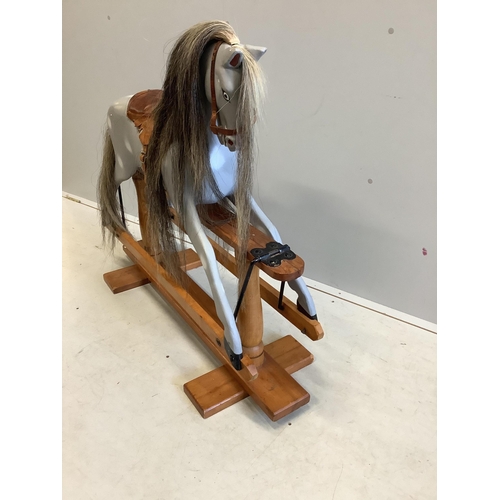 1102 - A small 1950's Ayers type dapple grey rocking horse on pine safety frame, later painted, width 106cm... 