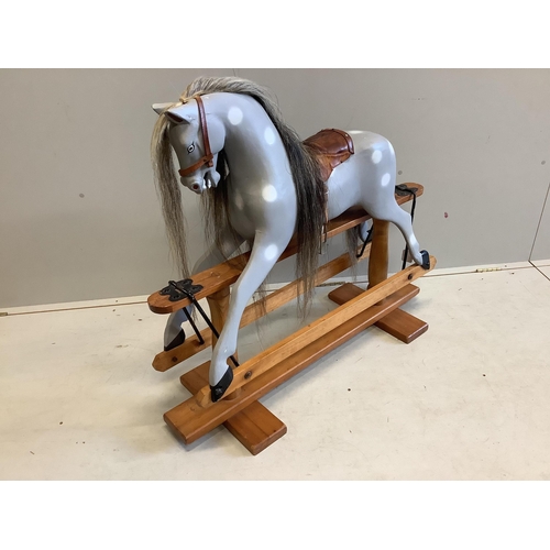 1102 - A small 1950's Ayers type dapple grey rocking horse on pine safety frame, later painted, width 106cm... 