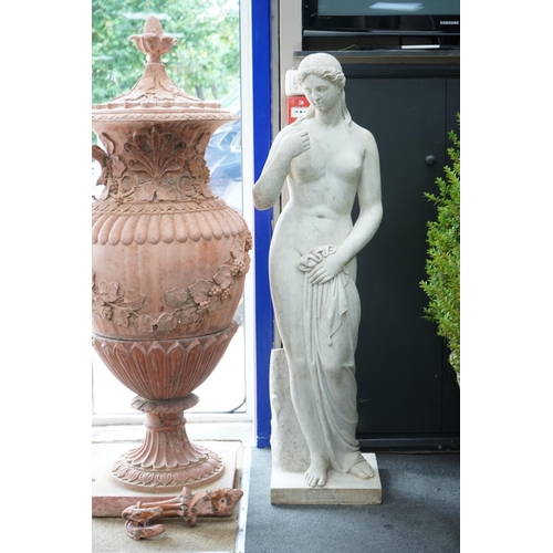 1120 - After the Antique. A large carved reconstituted marble figure of Venus, standing beside a tree trunk... 