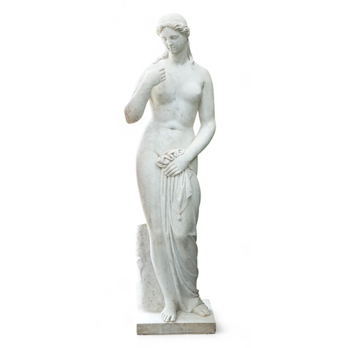 1120 - After the Antique. A large carved reconstituted marble figure of Venus, standing beside a tree trunk... 