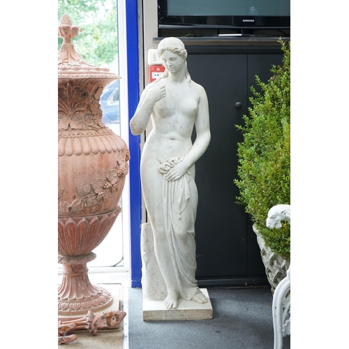 1120 - After the Antique. A large carved reconstituted marble figure of Venus, standing beside a tree trunk... 