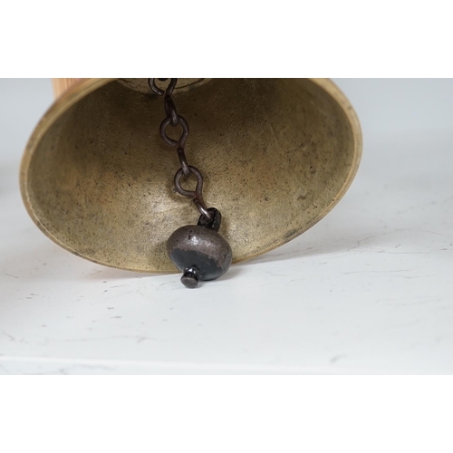 1306 - A late 19th/early 20th century brass school bell, with a turned mahogany handle, bell diameter 12.5c... 