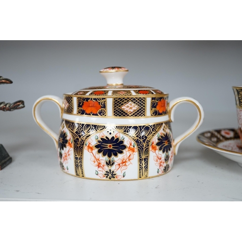 1310 - Two Royal Crown Derby sugar bowls, and a cup and saucer, largest 9cm high. Condition - good.