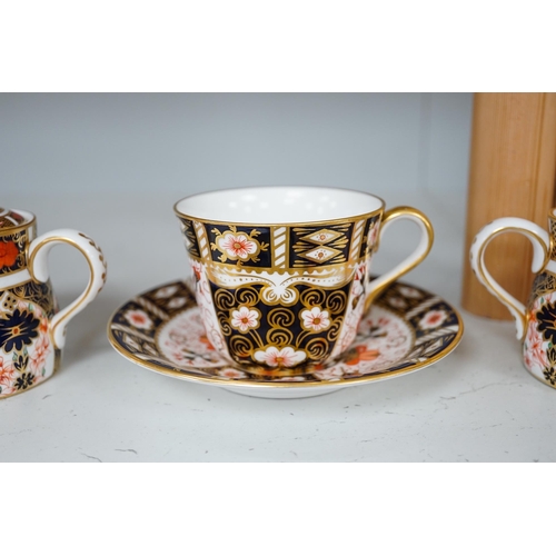 1310 - Two Royal Crown Derby sugar bowls, and a cup and saucer, largest 9cm high. Condition - good.