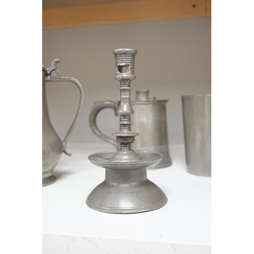 1343 - Six items of 18th century and later pewter including a jug, candlesticks, a pint measure, and a bron... 