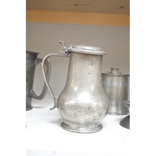 1343 - Six items of 18th century and later pewter including a jug, candlesticks, a pint measure, and a bron... 