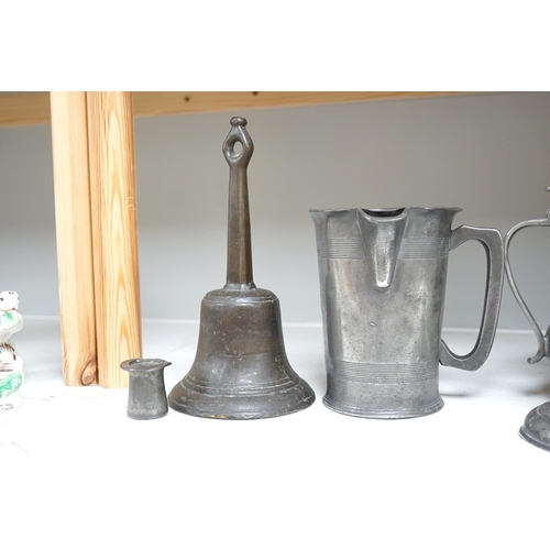 1343 - Six items of 18th century and later pewter including a jug, candlesticks, a pint measure, and a bron... 