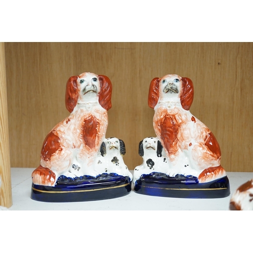 1356 - A pair of mid 19th century Staffordshire spaniel and puppy groups, a pair of smaller Staffordshire s... 