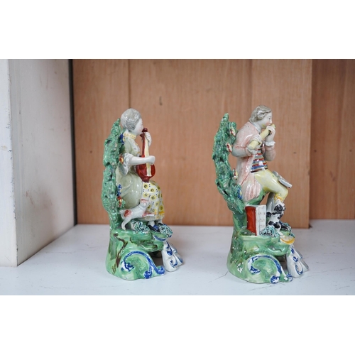 1362 - A pair of early 19th century pearlware groups of seated musicians with dogs, 15.5 cm high, Condition... 