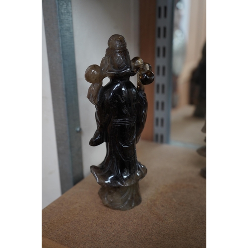 1392 - A 19th century Chinese smoky quartz figure of a lady holding a prunus branch, 19.5cm high. Condition... 