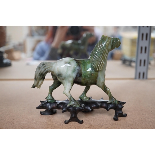 1394 - A pair of mid 20th century Chinese jadeite figures of horses, raised on hardwood stands, 13cm wide. ... 