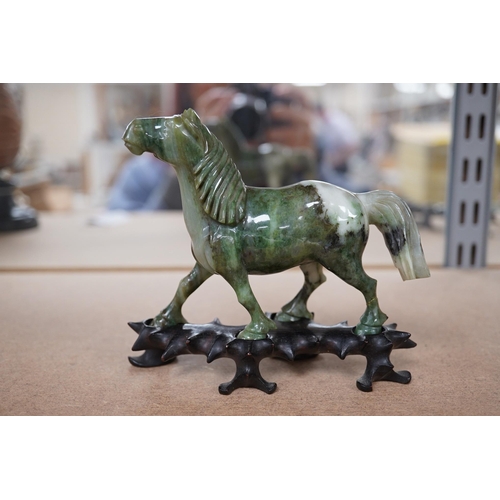 1394 - A pair of mid 20th century Chinese jadeite figures of horses, raised on hardwood stands, 13cm wide. ... 