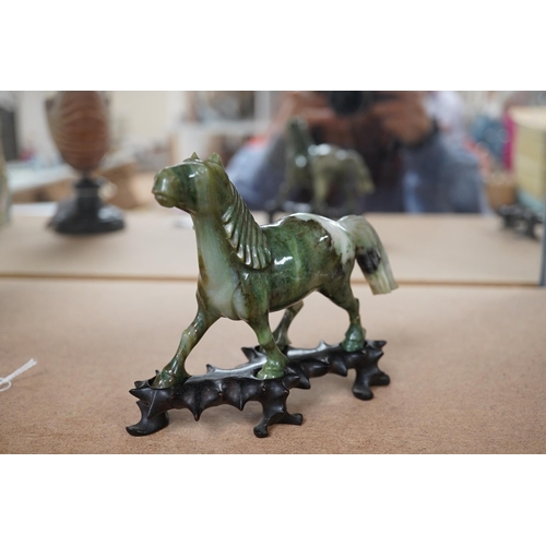 1394 - A pair of mid 20th century Chinese jadeite figures of horses, raised on hardwood stands, 13cm wide. ... 