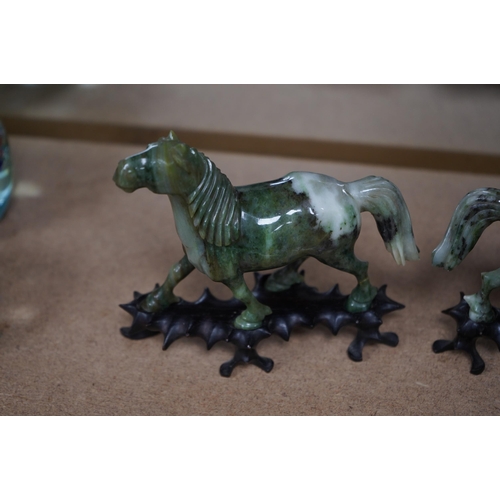 1394 - A pair of mid 20th century Chinese jadeite figures of horses, raised on hardwood stands, 13cm wide. ... 