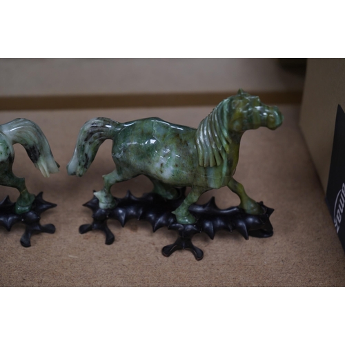 1394 - A pair of mid 20th century Chinese jadeite figures of horses, raised on hardwood stands, 13cm wide. ... 