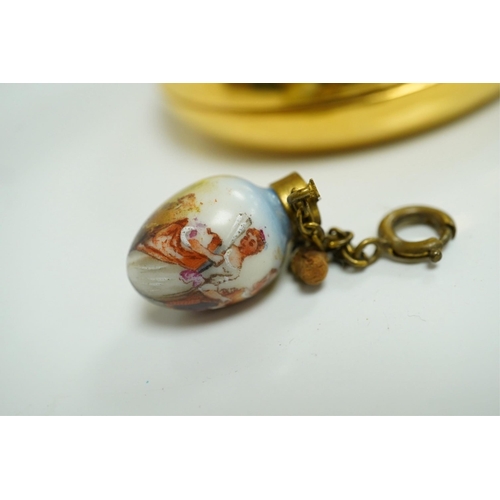 1402 - A miniature porcelain egg shaped scent bottle, on chain, two Halcyon Days scent bottles and a circul... 