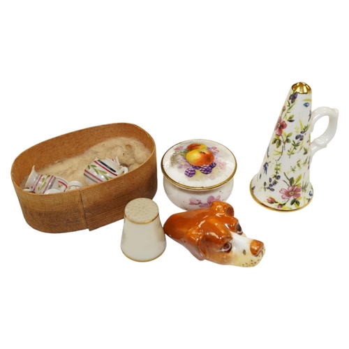 1409 - A mixed collection of miniature items including a Royal Worcester hounds head whistle, a candle ext... 