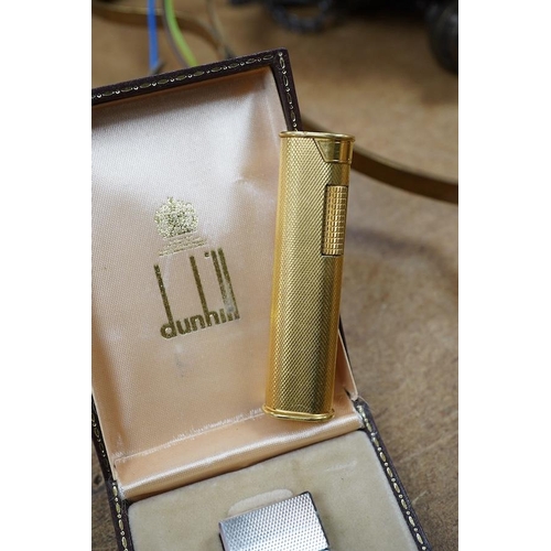 1414 - Two Dunhill Rollalite lighters, gold plated and silver. Condition - fair to good