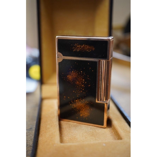 1415 - A cased Dupont 'gold dust' lighter with booklet. Condition - good