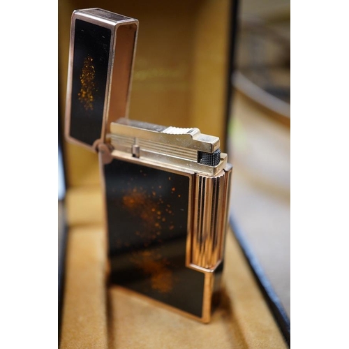 1415 - A cased Dupont 'gold dust' lighter with booklet. Condition - good