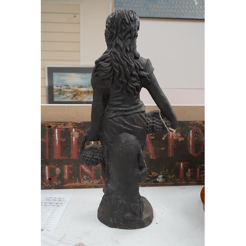 1428 - A cast iron figure of a grape harvester, 65cm high. Condition - fair to good.