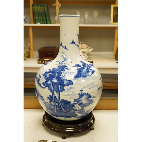 1429 - A Chinese blue and white bottle vase decorated with a landscape, 47cm high. Condition - poor