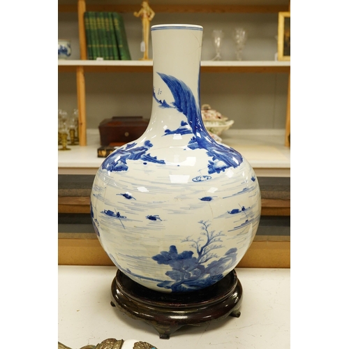 1429 - A Chinese blue and white bottle vase decorated with a landscape, 47cm high. Condition - poor