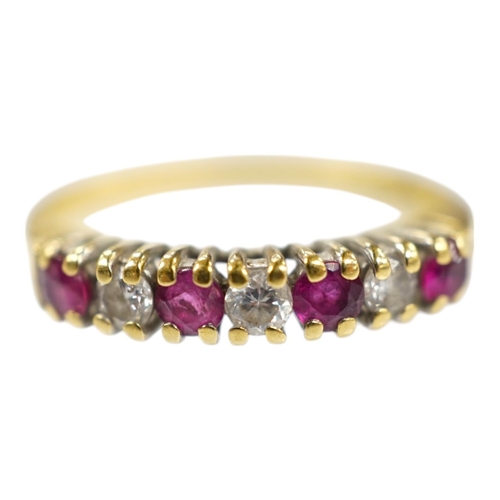 1903 - A modern 18ct gold, four stone ruby and three stone diamond set half hoop ring, size P, gross weight... 