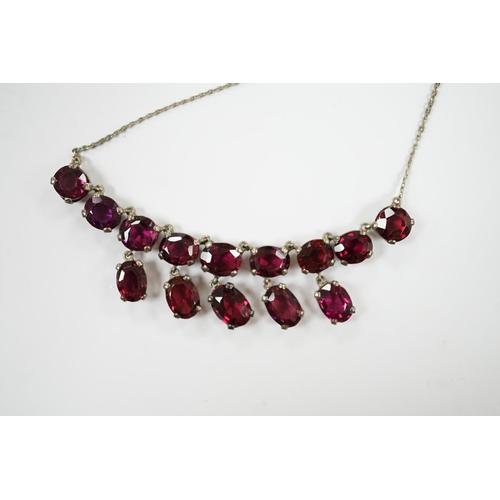 1914 - A white metal and garnet cluster set drop necklace, overall 48cm, together with a white metal, sapph... 