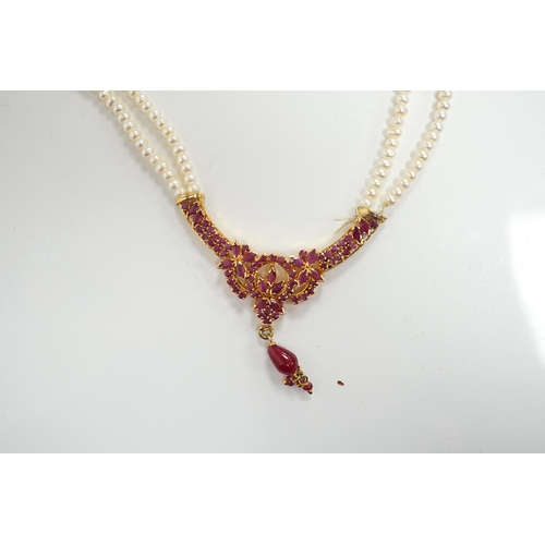 1915 - A recent Indian gilt metal and freshwater pearl and ruby cluster set twin strand necklace, 46cm and ... 