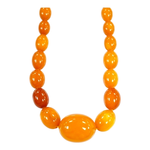 1918 - A single strand graduated oval amber bead necklace, 66cm, gross weight 48 grams. Condition - poor to... 