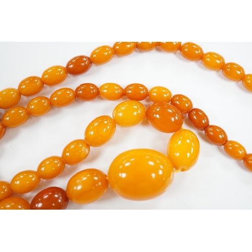 1918 - A single strand graduated oval amber bead necklace, 66cm, gross weight 48 grams. Condition - poor to... 