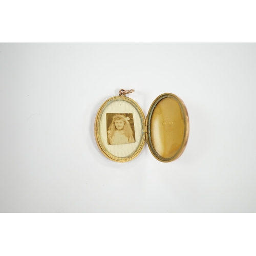 1923 - A George V engraved 9ct gold oval locket, 35mm, gross weight 11.7 grams. Condition - fair to good... 