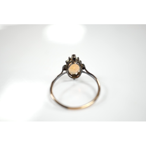 1924 - An antique, yellow and white metal, white opal and diamond set ring, size T, gross weight 2.1 grams.... 