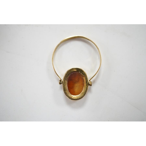 1935 - A 19th century French? yellow metal and oval intaglio paste set swivelling ring, size N, gross weigh... 