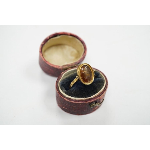 1935 - A 19th century French? yellow metal and oval intaglio paste set swivelling ring, size N, gross weigh... 