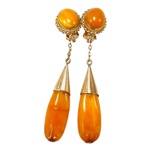 1940 - A pair of yellow metal and two stone amber set drop ear clips, 68mm, gross weight 8 grams. Condition... 