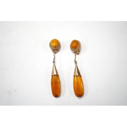 1940 - A pair of yellow metal and two stone amber set drop ear clips, 68mm, gross weight 8 grams. Condition... 