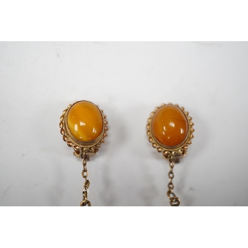 1940 - A pair of yellow metal and two stone amber set drop ear clips, 68mm, gross weight 8 grams. Condition... 