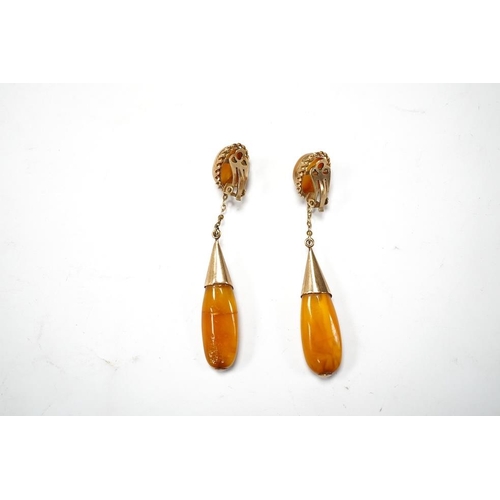 1940 - A pair of yellow metal and two stone amber set drop ear clips, 68mm, gross weight 8 grams. Condition... 