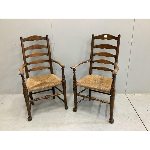 114 - A pair of 19th century beech ladder back elbow chairs, width 54cm, depth 49cm, height 105cm. Conditi... 