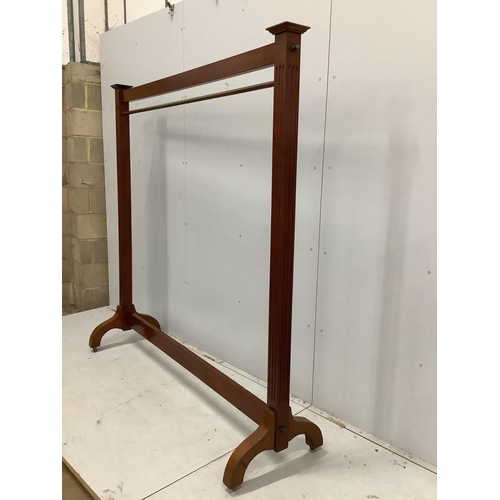 123 - A mahogany dress rack, with reeded uprights, ex Libertys, width 182cm, height 184cm. Condition - fa... 