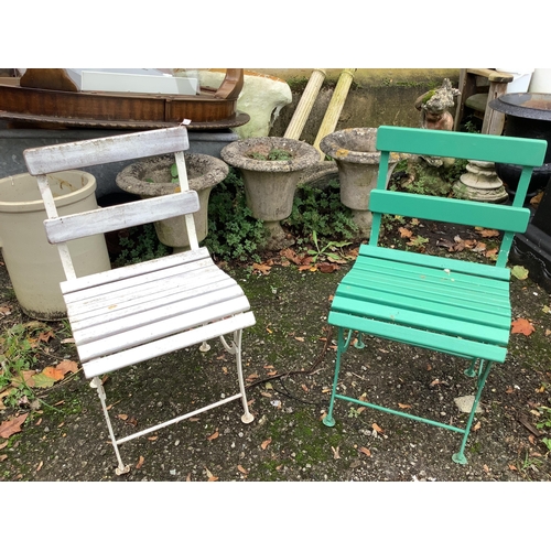 133 - A slatted teak wrought iron garden bench, width 155cm and a pair of similar painted chairs. Conditio... 