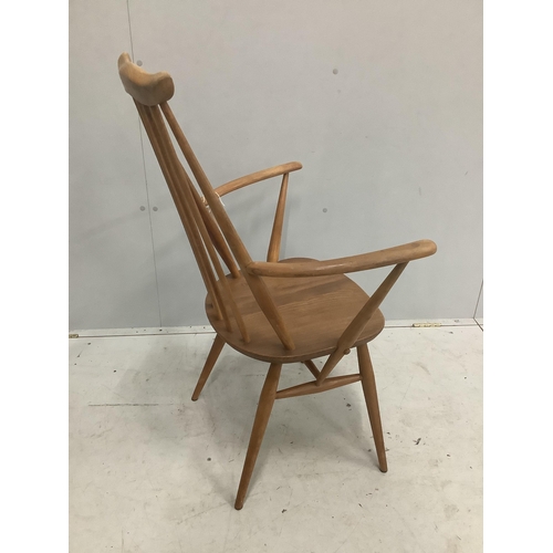 16 - An Ercol Goldsmith's comb back elbow chair, width 61cm, depth 41cm, height 98cm. Condition - fair... 