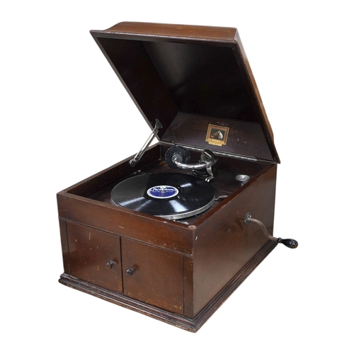 304 - A mahogany cased HMV table top gramophone record player and a small selection of 78 rpm records. Con... 