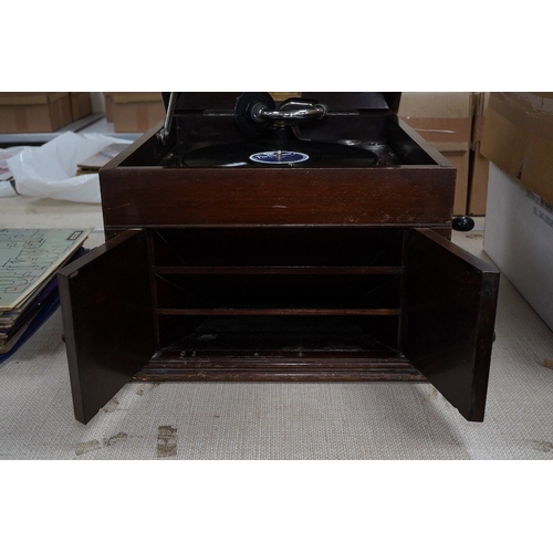 304 - A mahogany cased HMV table top gramophone record player and a small selection of 78 rpm records. Con... 