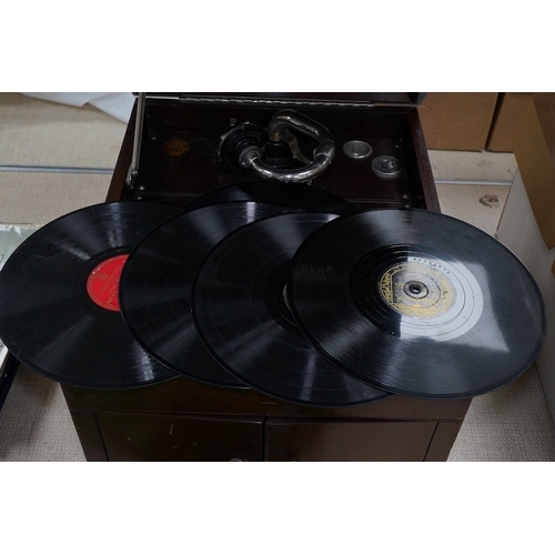 304 - A mahogany cased HMV table top gramophone record player and a small selection of 78 rpm records. Con... 