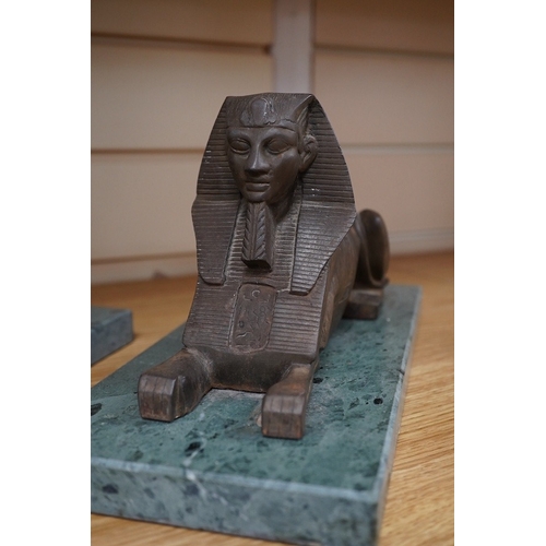 361 - A pair of bronze models of Sphinxes, raised on green serpentine marble bases, 32cm long. Condition -... 