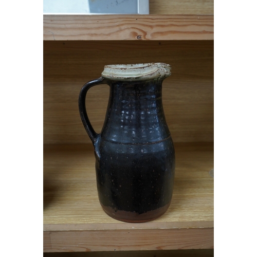 364 - Richard Batterham (1936-2021), a tall stoneware black glazed jug, with a cream rim. 28cm high. Condi... 